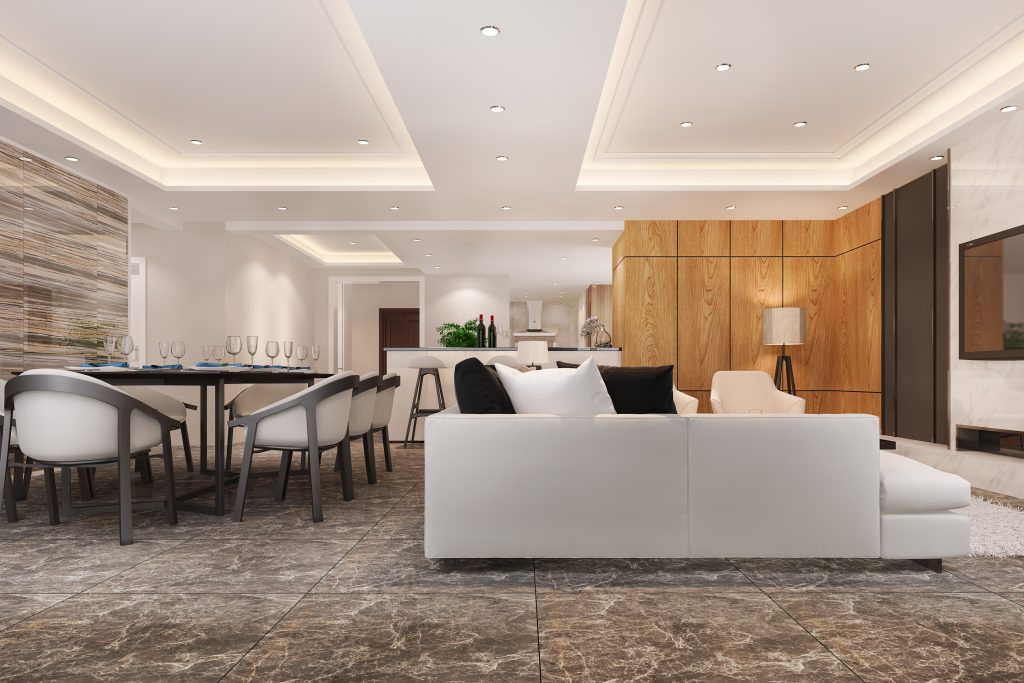 Ambiente moderno e sofisticado com sala de estar, sala de jantar e cozinha integradas, decorado com tons neutros, móveis elegantes e iluminação embutida.
