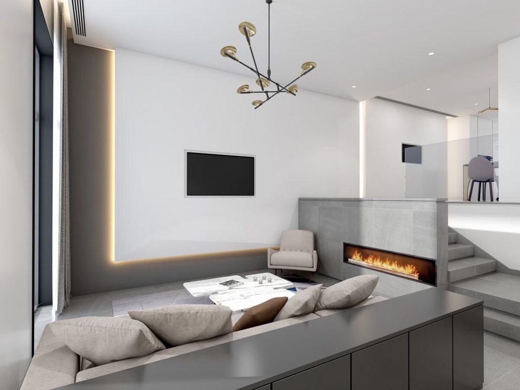 Sala de estar moderna e minimalista com sofá bege, lareira embutida, poltrona, mesa de centro de mármore e iluminação indireta.