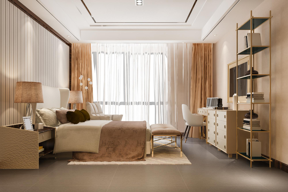 Quarto moderno em tons terrosos, com cama de casal, poltrona, penteadeira, prateleiras e cortinas translúcidas que deixam a luz natural entrar.