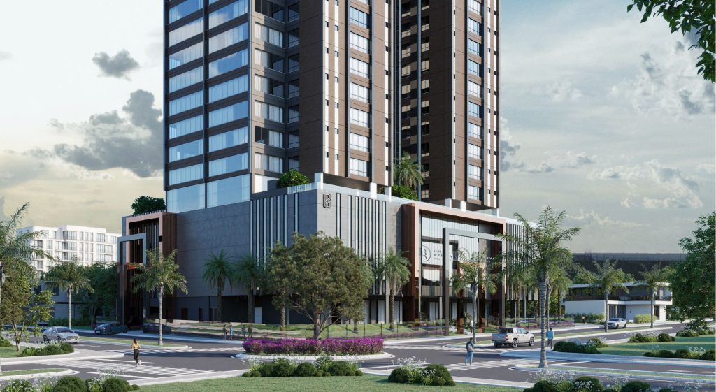 Renderização realista de um empreendimento residencial de alto padrão com duas torres modernas, fachada em tons de marrom e cinza, grandes janelas espelhadas e áreas verdes no topo. A base do edifício apresenta um design contemporâneo com linhas verticais e detalhes em vidro. Em primeiro plano, há uma rotatória com canteiro florido, árvores, palmeiras e pessoas caminhando, transmitindo um ambiente urbano sofisticado e bem planejado.